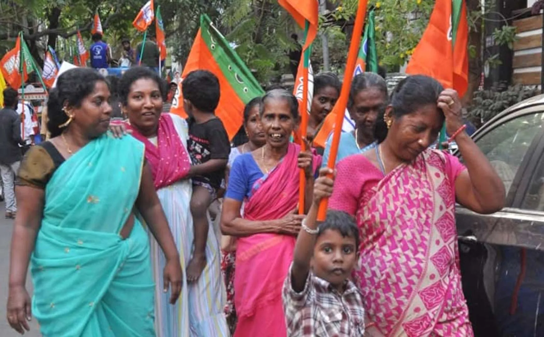 Children hold flags and campaign for BJP candidate's vote collection (Pictures)