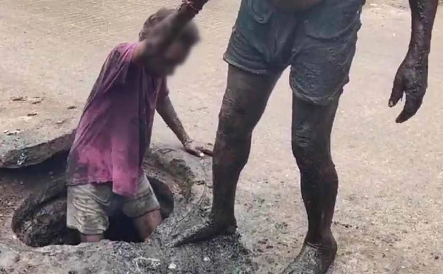Workers who go down the drain without protection and scoop waste