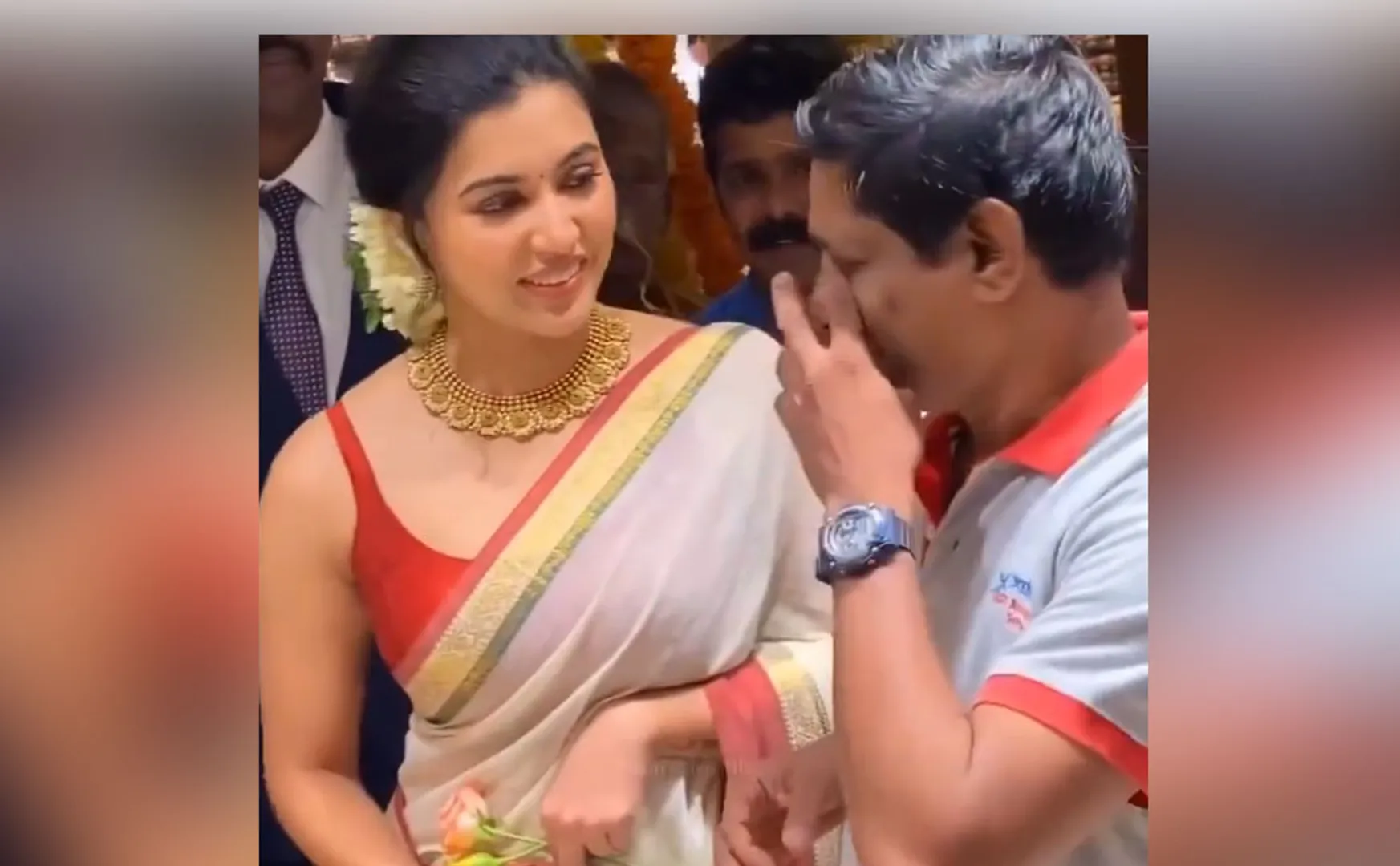 A fan who came to take a photo with Anju Kurien fell on his feet