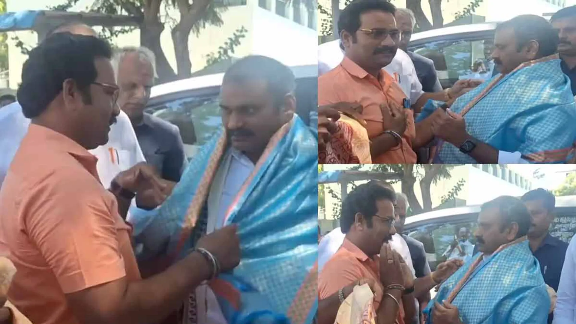 L. Murugan looked at the volunteer with his upper hand while putting on the shawl