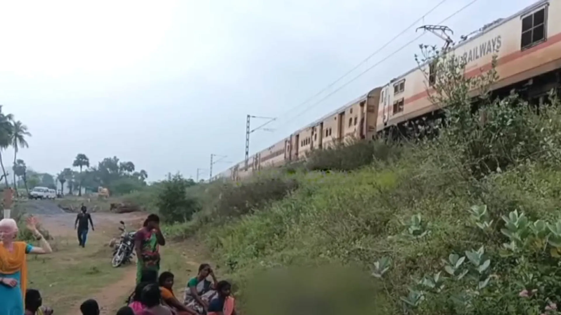 School students trying to cross while playing games on cell phones; Train collision accident