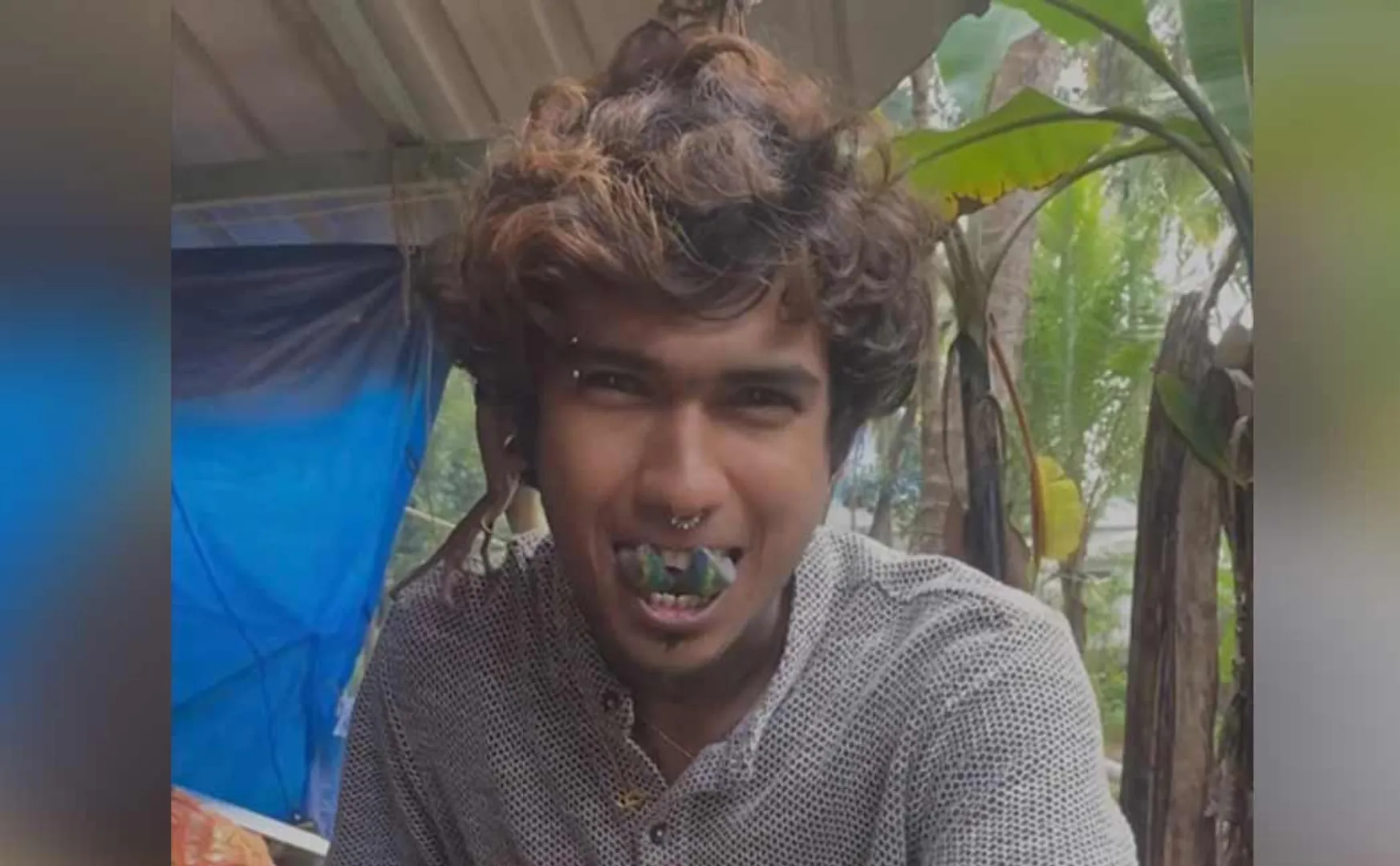 oung man with a split tongue and a tattoo
