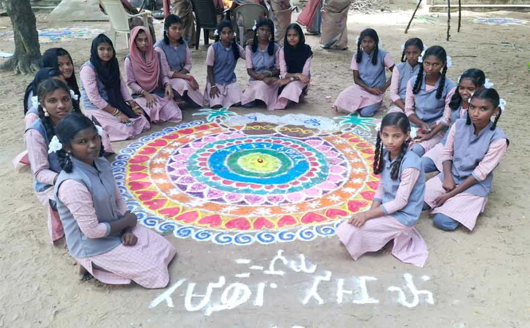 kolam floating on water Pongal greetings in Tamil writing Govt school girls are amazing