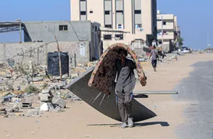 A Palestinian man flees from the Hamad residential city northwest of the southern Gaza Strip city of Khan Younis