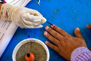 Amritsar: An election official marks a voter's finger with the indelible ink during the seventh and last phase of Lok Sabha polls