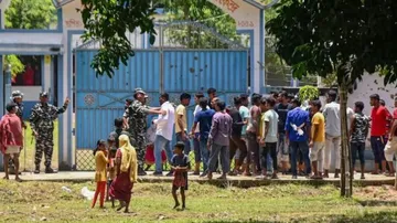 Police personnel trying to maintain law and order after a clash between rival political groups durin