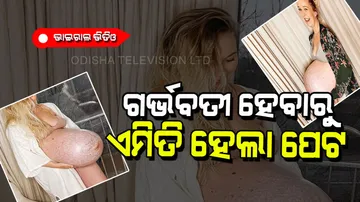 9 months pregnant woman shows unique baby bump