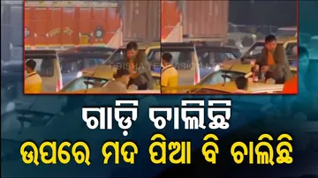 Viral Video: Man Drinks Alcohol On Car Roof