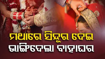 man puts sindoor on woman at her wedding with another