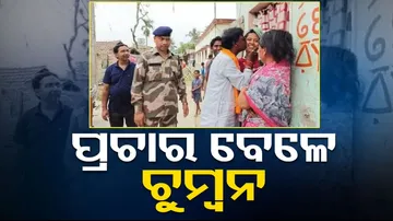 kisses woman during campaign