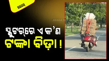 A man carrying notes on scooter watch false information checked by internet