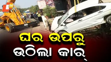 Car Lifted from House After Overbridge Crash; Locals Demand Compensation