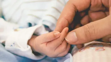 Holding a infant's hand