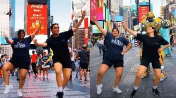 Indian women groove with bumblebee robot at Times Square