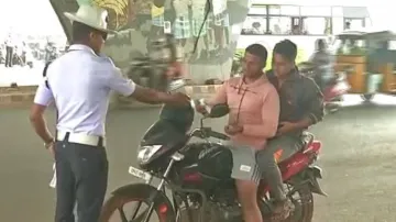 A traffic police in Bhubaneswar imposing fine on traffic rule violators