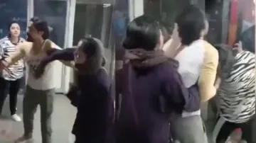 Extramarital affair of husband irks woman in Burqa, hits girl with slippers; watch