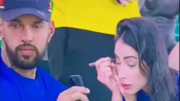 Watch: Man helps wife with makeup during live match