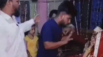 Lover kneels down before bride, pleads holding her legs