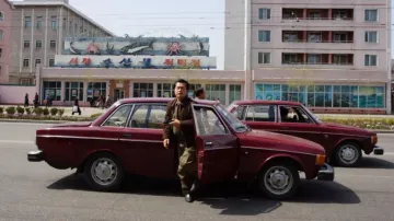 Man Alighting From A Volvo In North Korea
