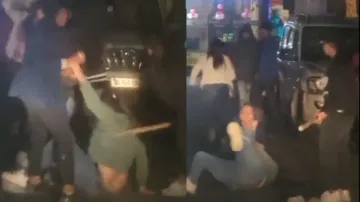 Two girls hit another girl violently with wooden log on road, watch