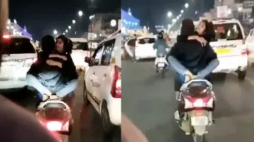 Lovebirds romance while riding two-wheeler on busy street; internet reacts after video goes viral