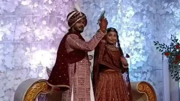 Couple fires shot on wedding stage