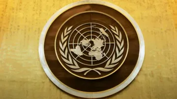 Plaque bearing the United Nations logo above the podium of the General Assembly Hall. 