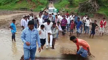 Supporters save MLA’s shoes, carry him through water