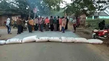 Paddy procurement delay: Farmers stage road blockade by spilling paddy on road