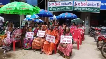 Women sell milk in front of liquor shop in Bhadrak