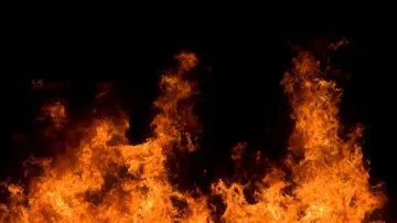 Anti-socials hurl bomb, set JCB machine on fire