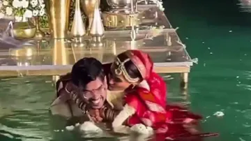 Bride pushes groom into pool, duo starts romancing in water; watch