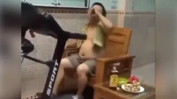 Laziest fitness freak ‘walks’ on treadmill while binging on alcohol & snacks; watch