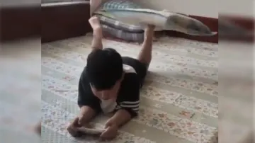 Kid spins pillow on feet while playing mobile game; amazing talent is shocking; watch