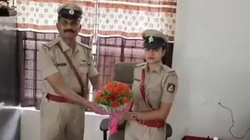Retiring Police sub-inspector welcomes daughter with flowers as she takes over his position