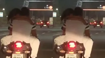 Another couple caught romancing, kissing on bike; video goes viral