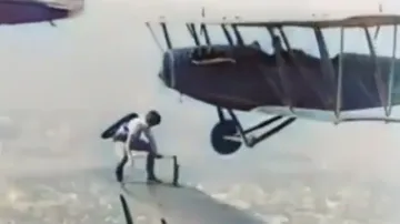 Watch brave woman jumping from one plane to another mid-air