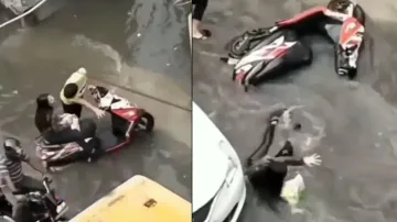 Girl enjoys ride as youth drags scooter on waterlogged road, watch what happens next
