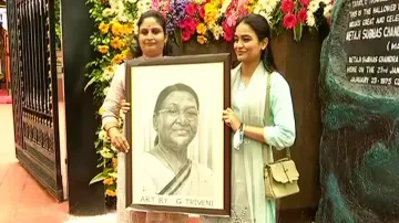 G Triveni (L) eagerly waits to present President Droupadi Murmu with her smiling portrait