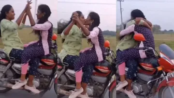 Girls lock lips on moving bike throwing safety norms to wind