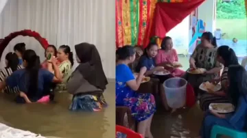 Group of women brave floodwater, enjoy wedding feast in waist-deep water; watch