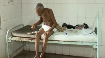 Destitute Patient eating Alone At Hospital Bed