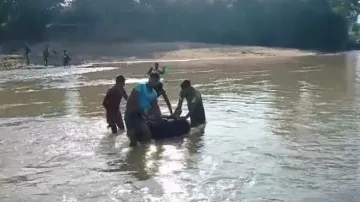 Patient crosses river in inflated tube