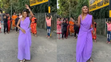Saree-clad woman dances on busy railway platform