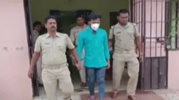 The accused being taken to the police station.