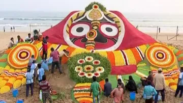 Sudarsan Pattnaik creates Lord Jagannath’s sand sculpture with flowers in Puri 