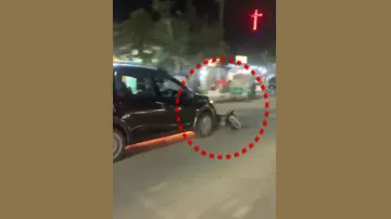 Car Drags Scooter On Road