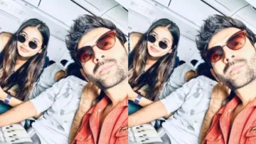 Kartik Aaryan spotted flying Economy class once again, happily clicks pictures with lucky fan
