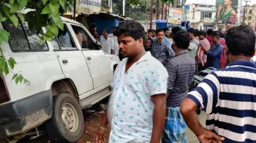 Police van falls into drain after hitting two persons