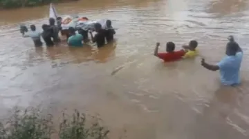 Villagers carry dead body through swollen river in Koraput
